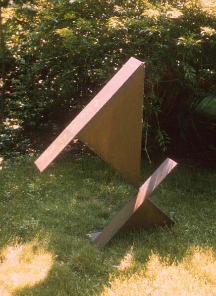 A sculpture of an object in the grass.