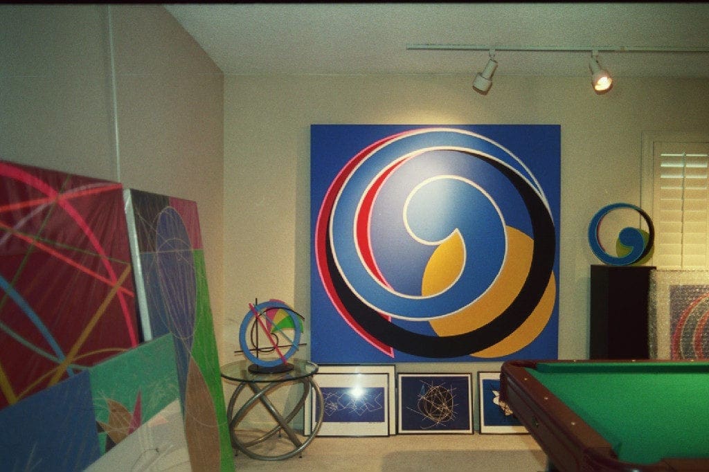 A room with paintings and a table in it