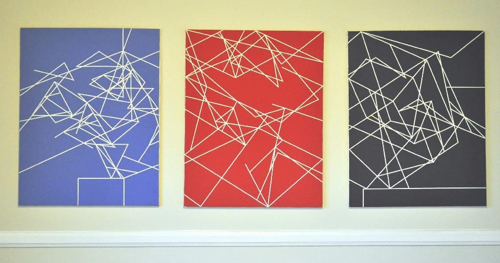 Three paintings of lines on a wall