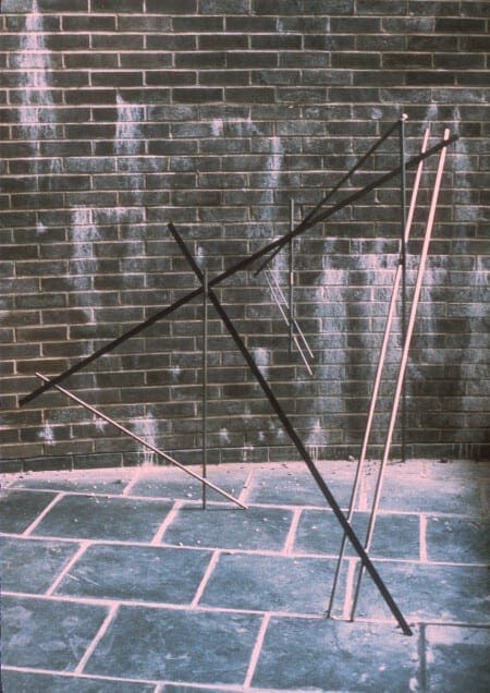 A brick wall with some poles and wires