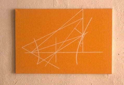 A picture of an orange wall with white lines.