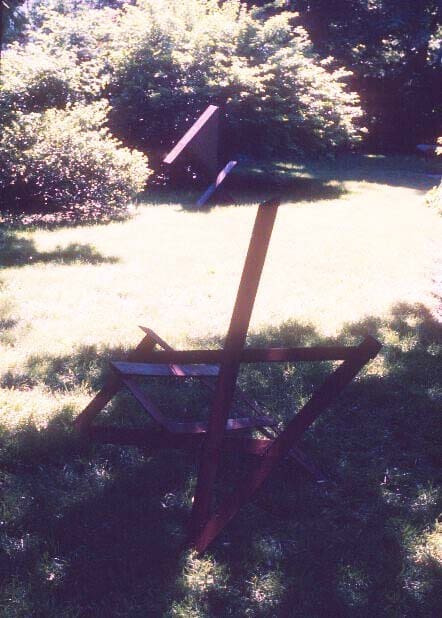 A metal object sitting in the middle of a field.