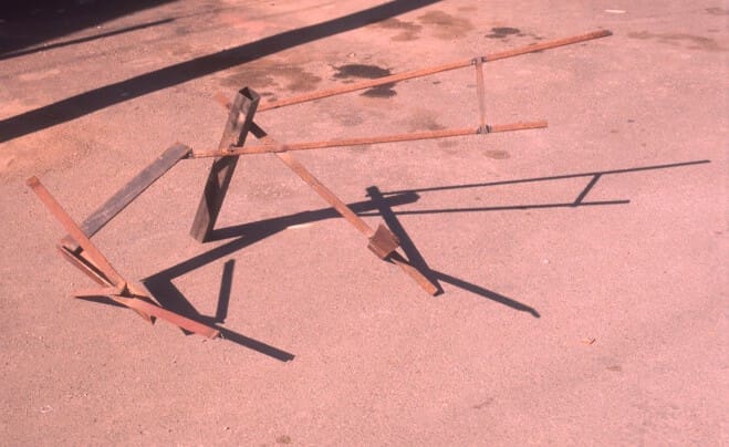 A group of metal sticks on the ground.