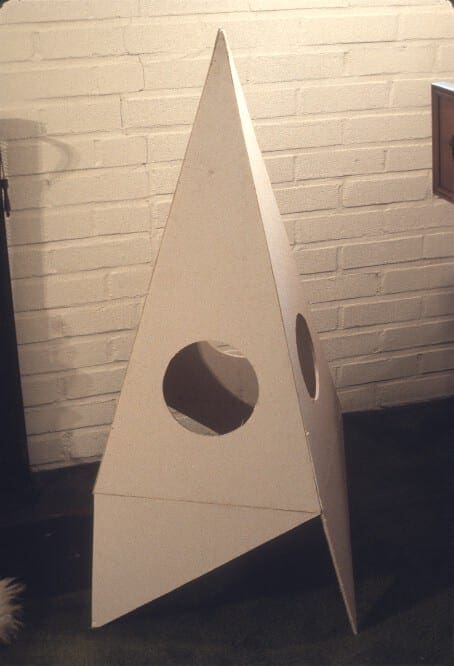 A white cardboard tower with holes for the top.