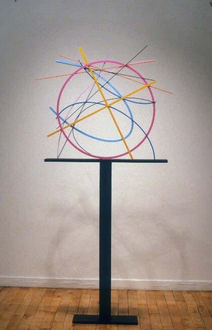 A sculpture of a circle with many lines on it.