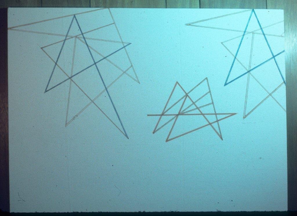 A white board with some brown sticks on it