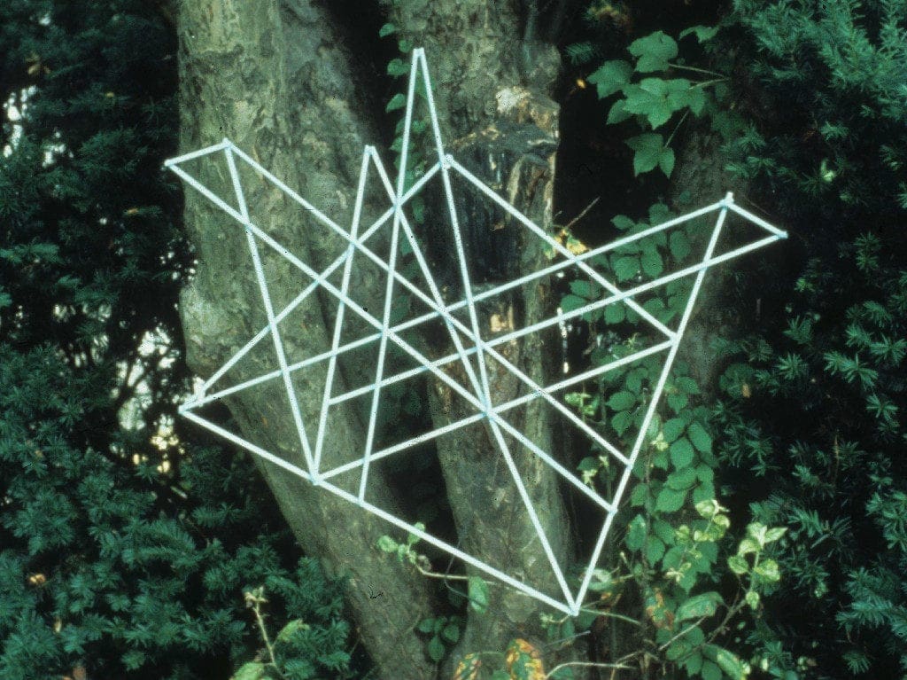 A tree with some sticks in the shape of an origami bird.