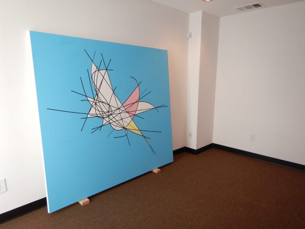 A large painting of a bird on the wall