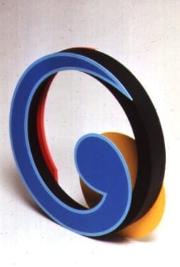 A blue letter sitting on top of a yellow and black object.