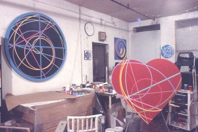 A room with two large red hearts and a white chair.