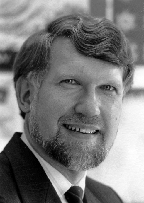 A black and white photo of a man with a beard.
