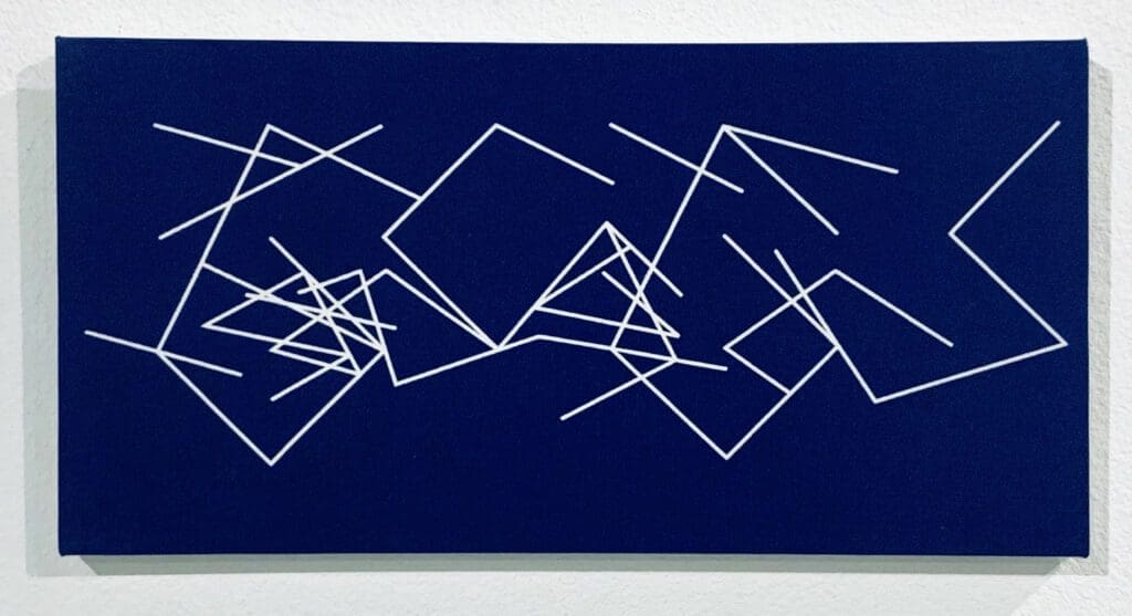 A blue and white painting of sticks on the wall