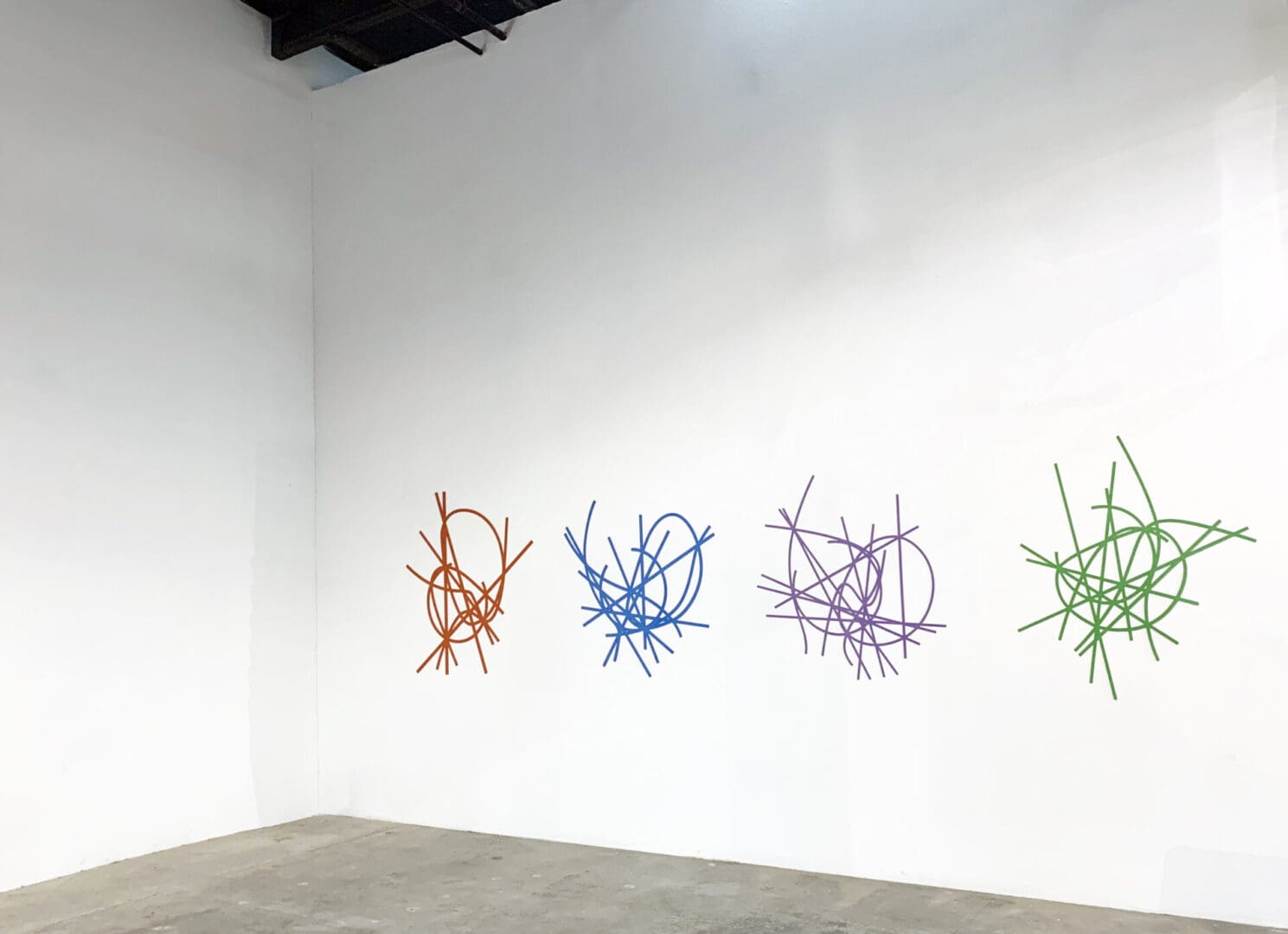 A room with several different colored sticks on the wall.