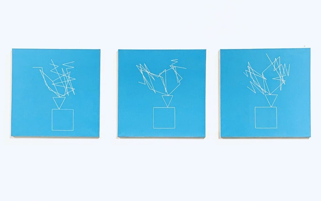 Three blue canvases with drawings of a bird on them.