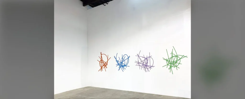 A room with several different colored sticks on the wall.