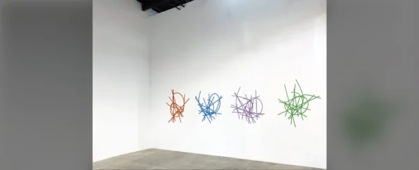 A room with several different colored sticks on the wall.