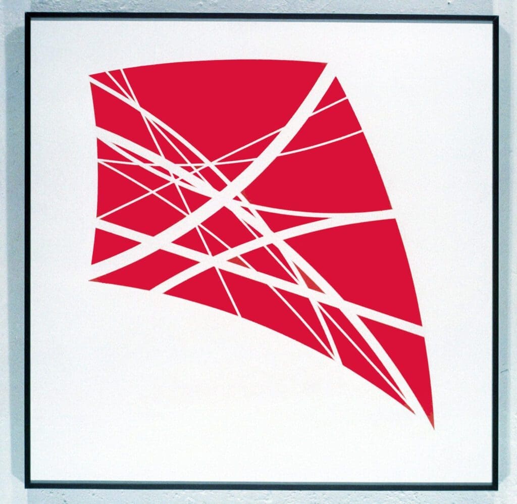 A red kite is in the shape of a triangle.