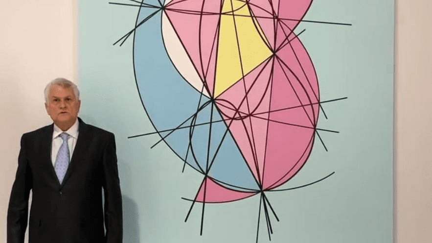 Geometric wall art with colorful intersecting shapes and black lines.