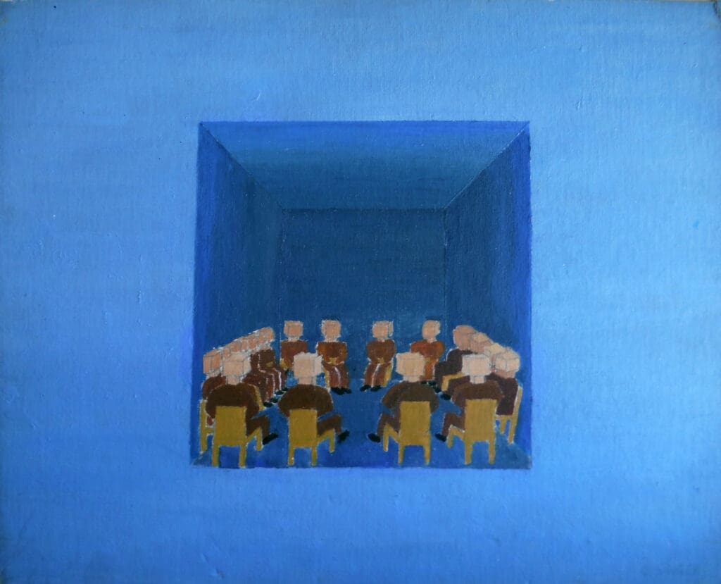 Eleven people sitting in a square room, facing each other around a table.