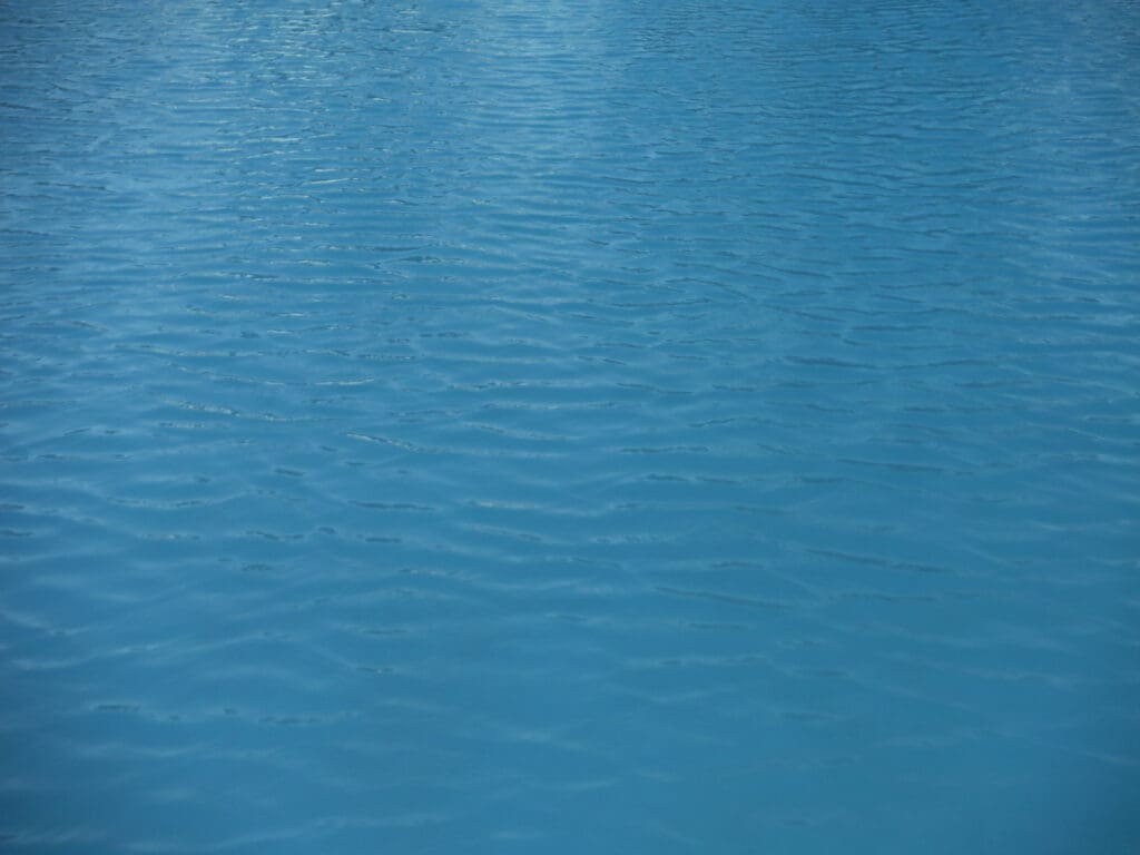 Close-up of calm blue water surface with gentle ripples.