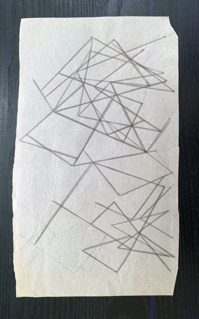 Abstract geometric line drawing on paper with intersecting shapes.