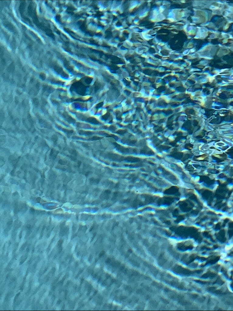 Turquoise pool ripples forming concentric rings
