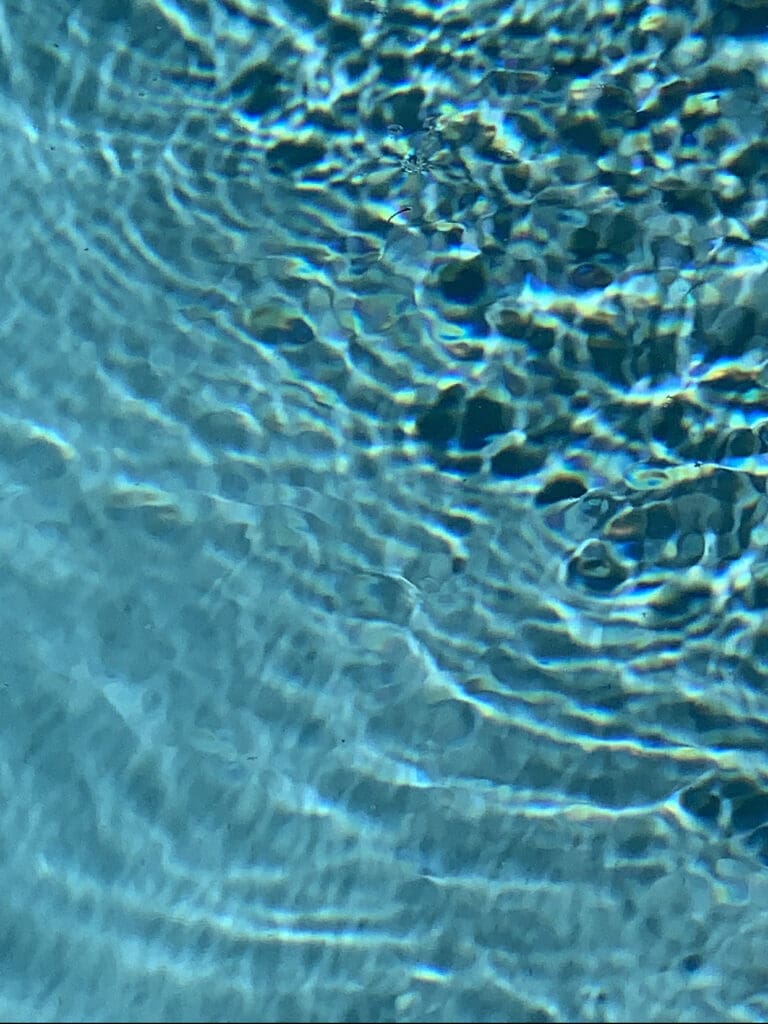 Clear blue water with light ripples and shadows.