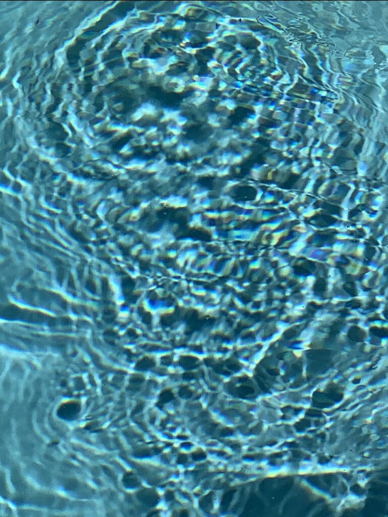 Close-up of rippling water surface with blue hues.