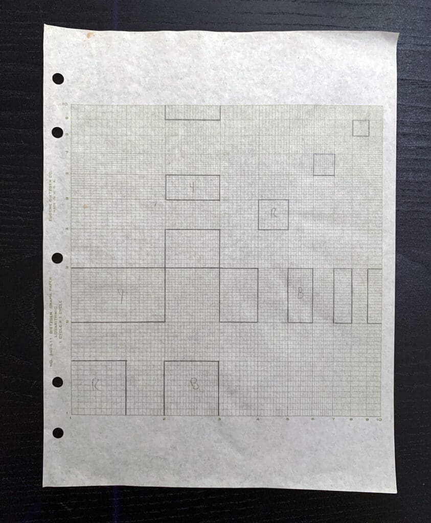 Hand-drawn architectural floor plan on graph paper with multiple rooms and annotations.