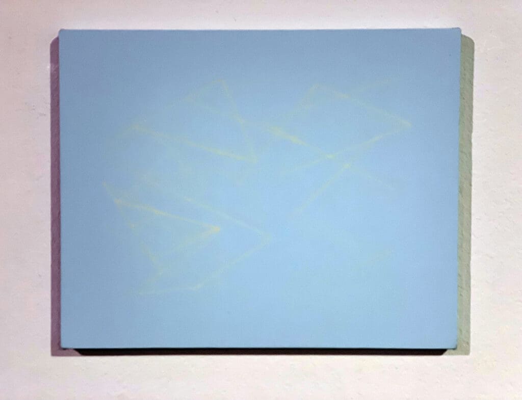 Light blue abstract painting on wall.