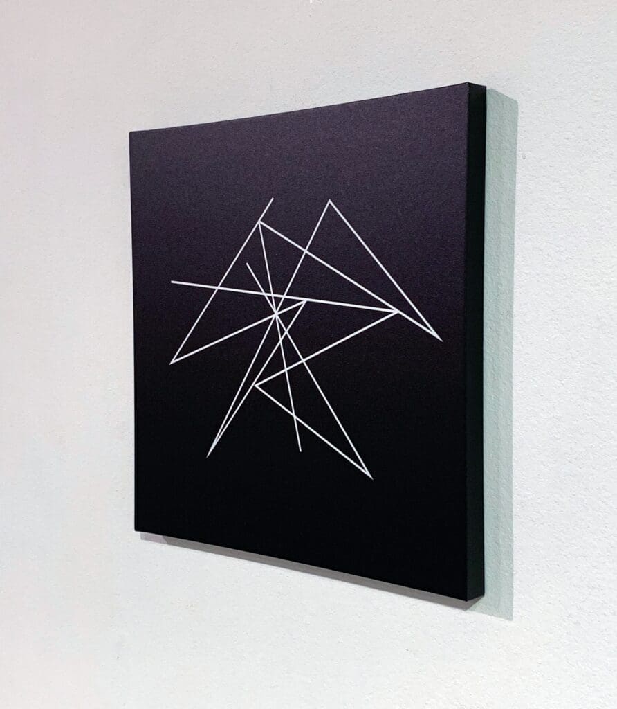Abstract geometric art with intersecting white lines.