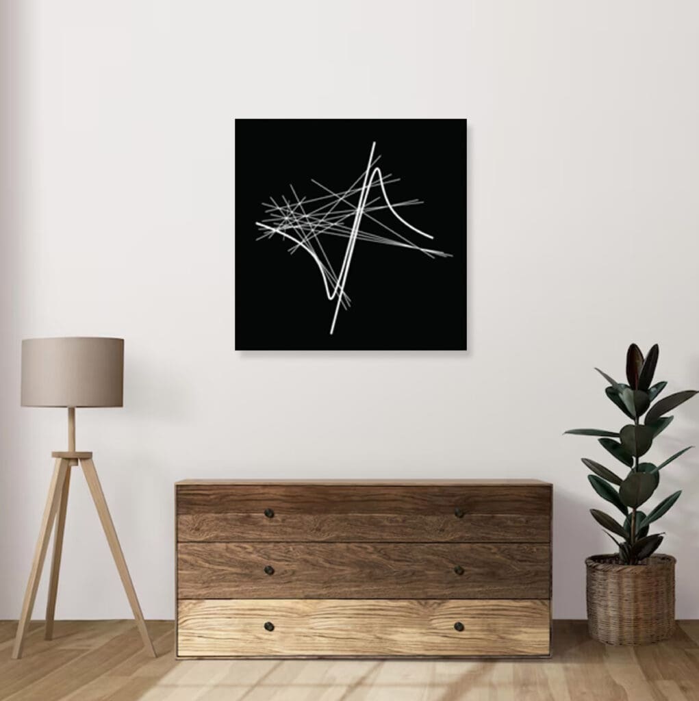 Abstract art above wooden cabinet and lamp.
