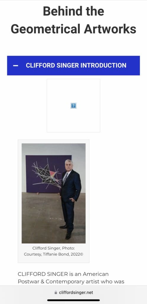 Man in suit standing before purple geometric painting