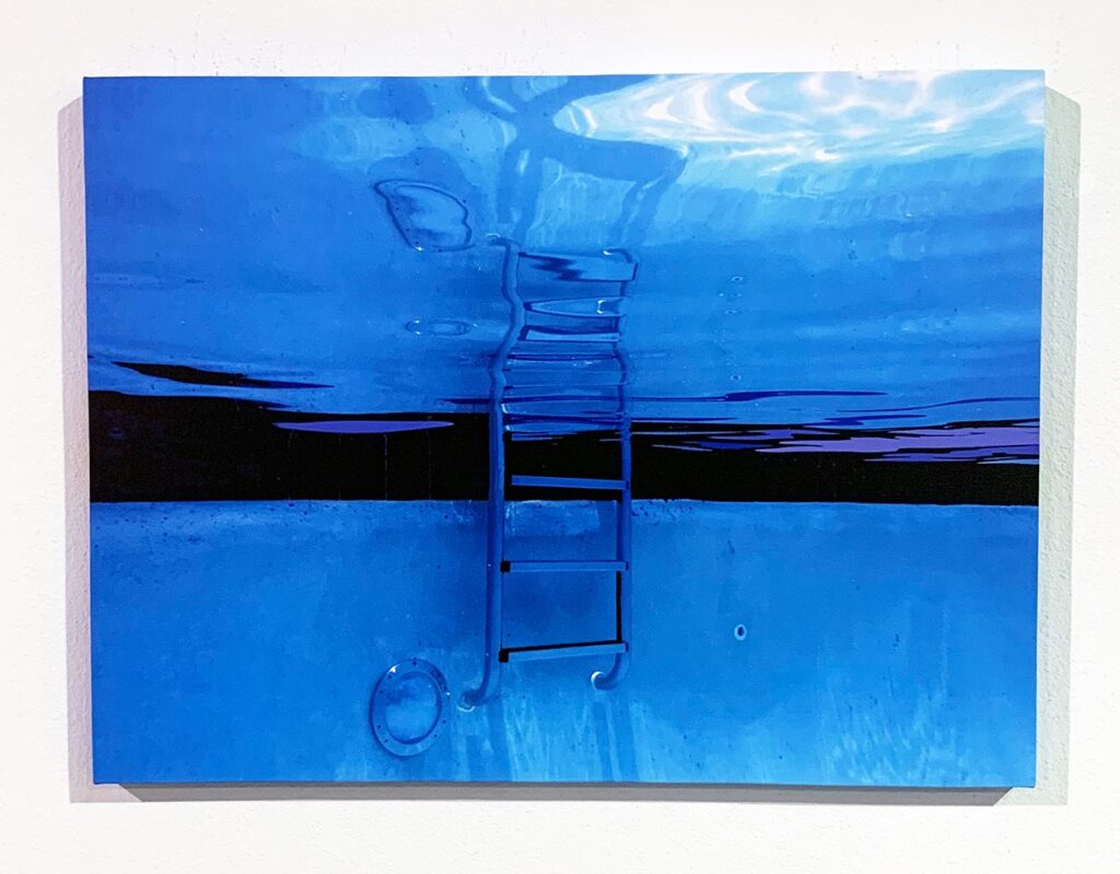 Underwater pool ladder with blue reflections