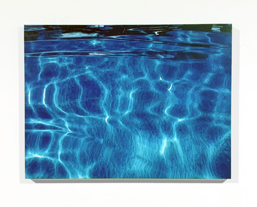 Blue pool water with sunlight ripples
