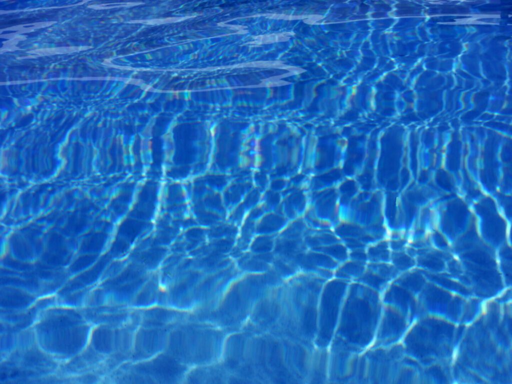 Blue pool surface with sunlit ripples