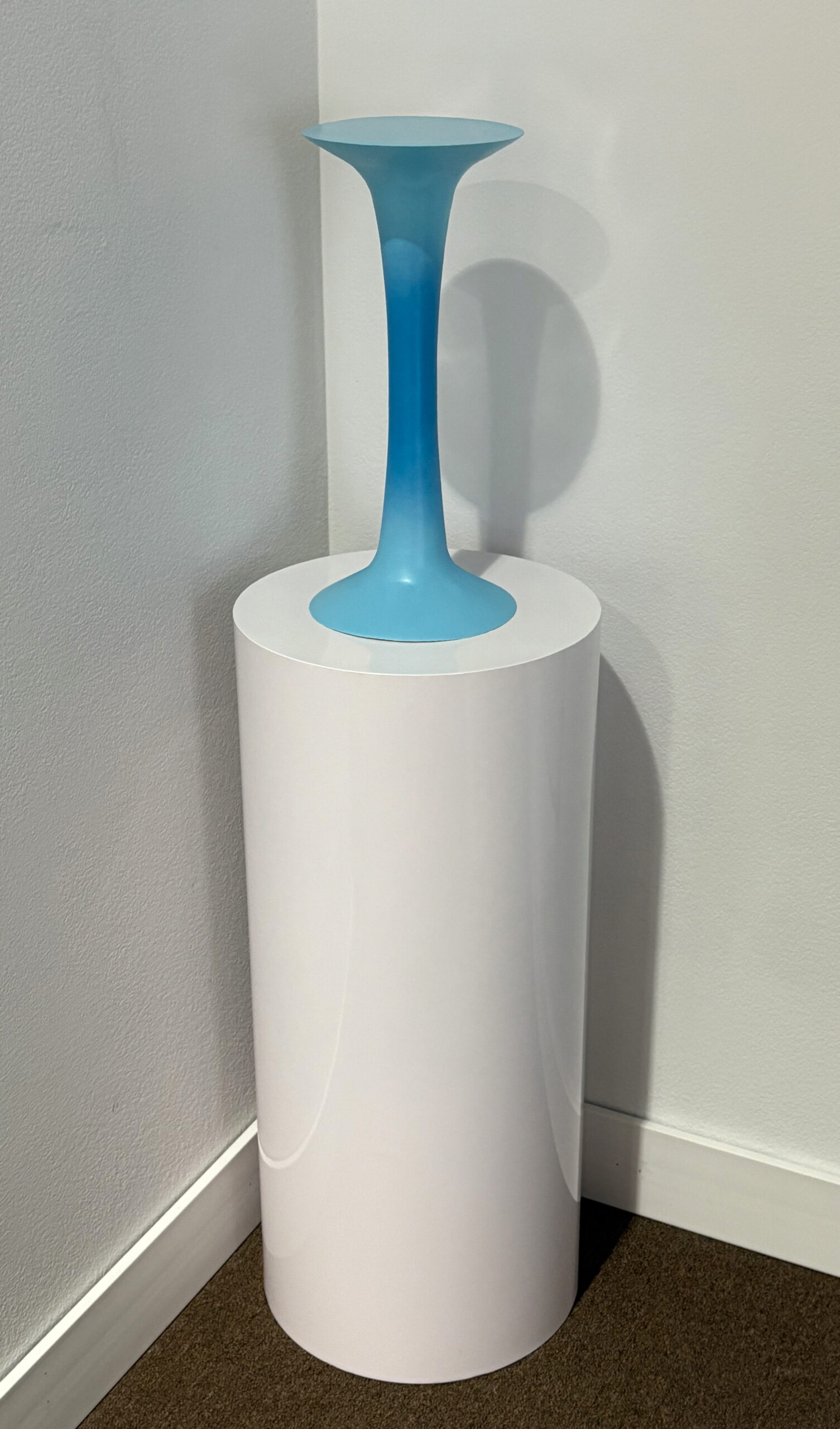 Modern toilet brush with a blue handle in a white holder.