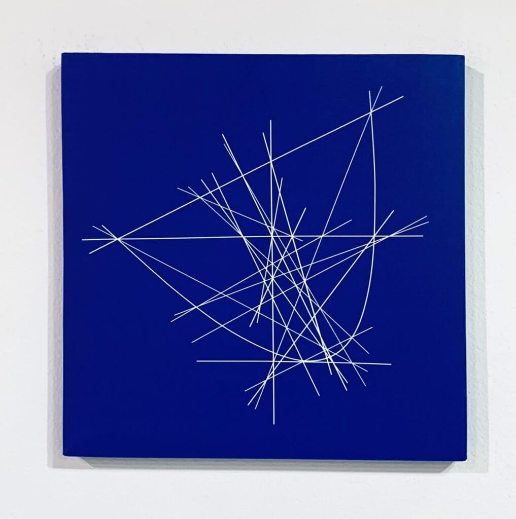 Abstract white line design on blue canvas