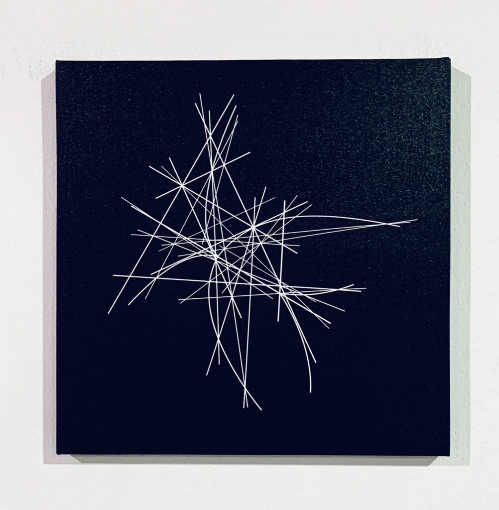 Black panel with intersecting white linear sketches