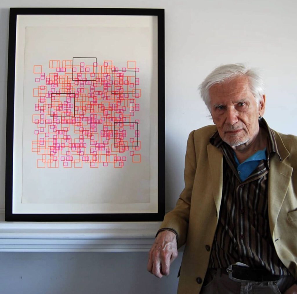 Elderly man beside framed abstract square artwork
