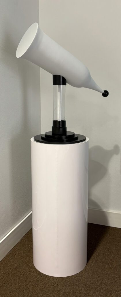 White horn-like sculpture on pedestal