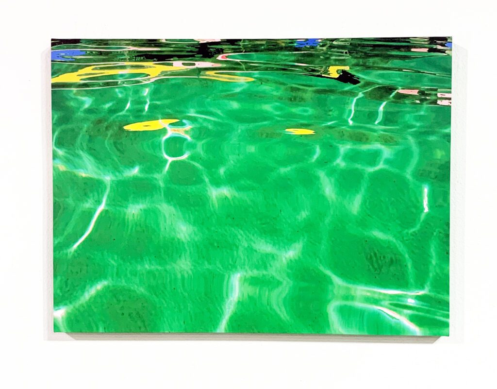 Emerald pool water with yellow reflections