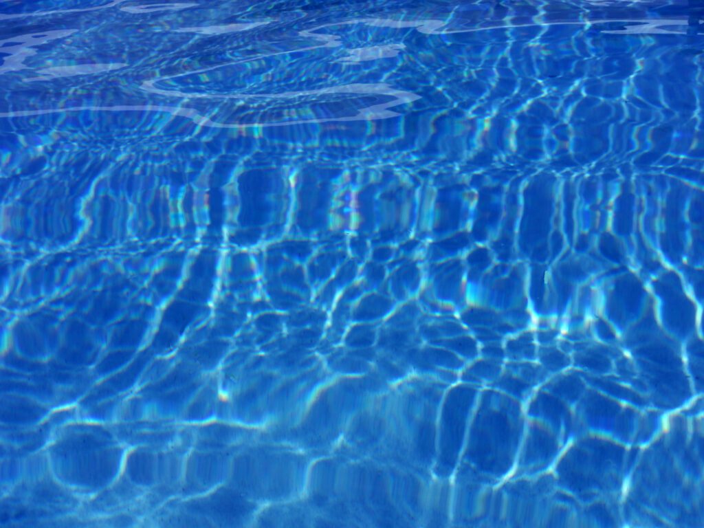 Crystal blue water with wavy light patterns
