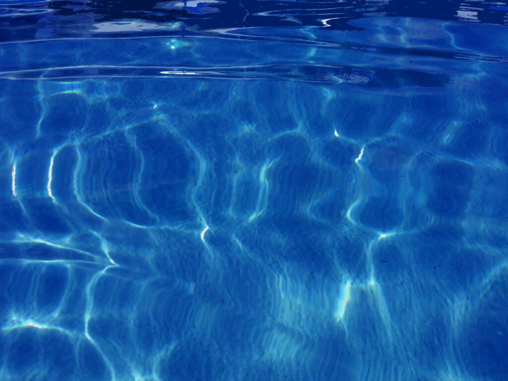 Sunlit rippling water creating wavy reflections