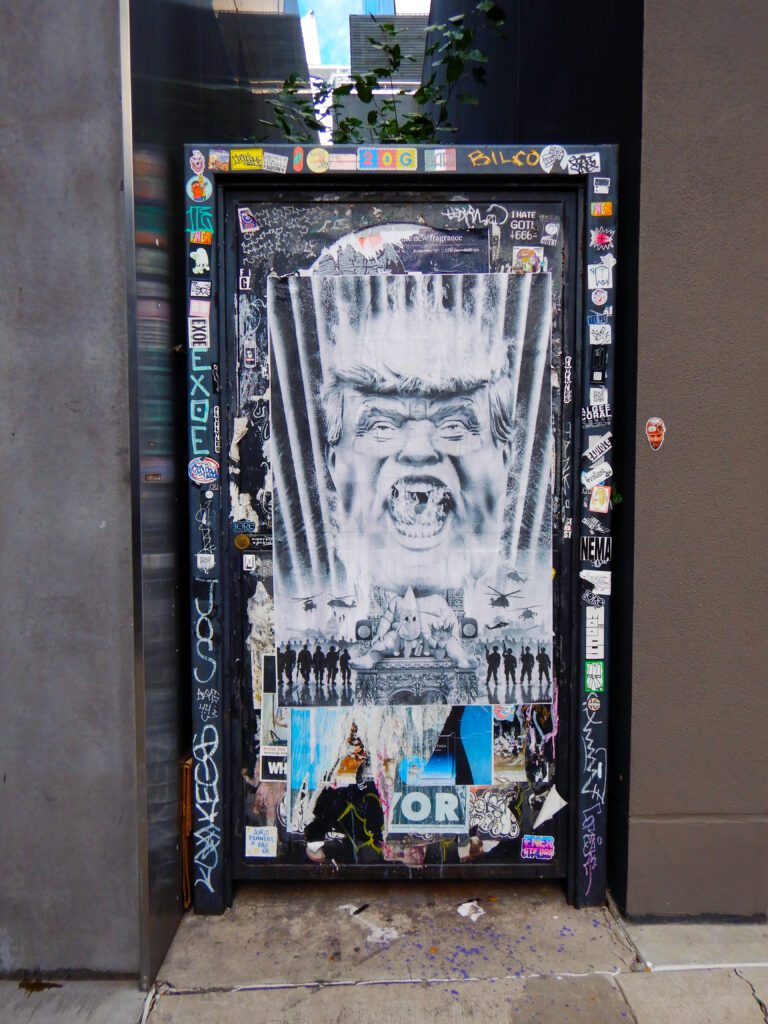Stencil poster of a screaming face in doorway