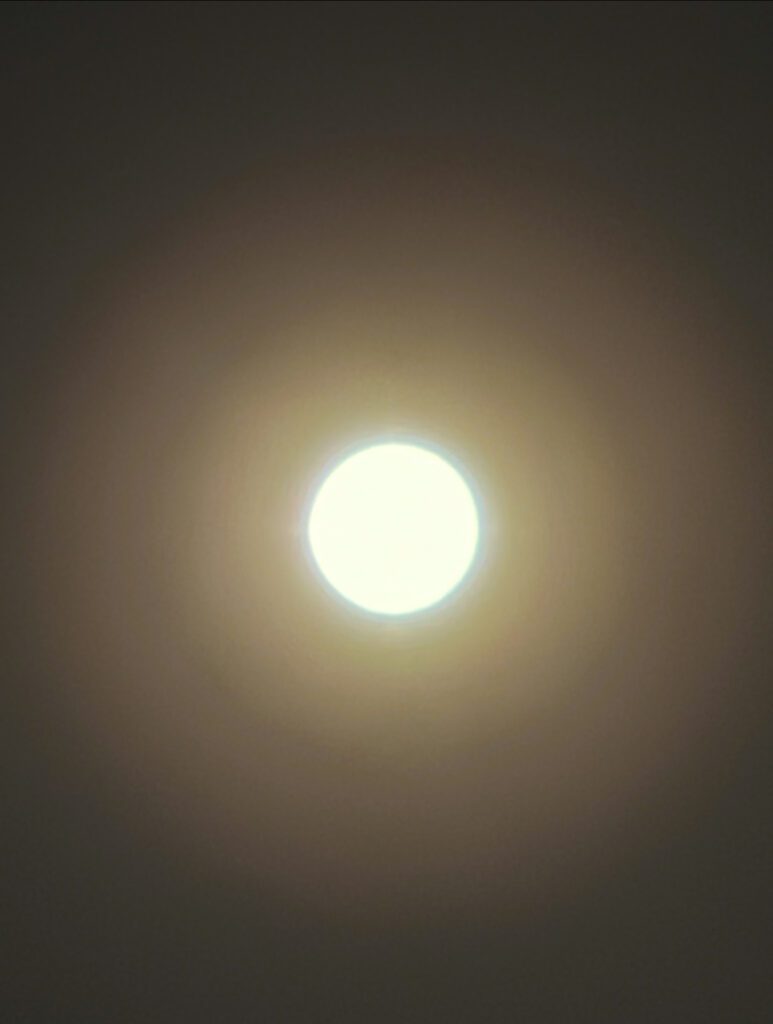 Warm halo surrounding bright full moon