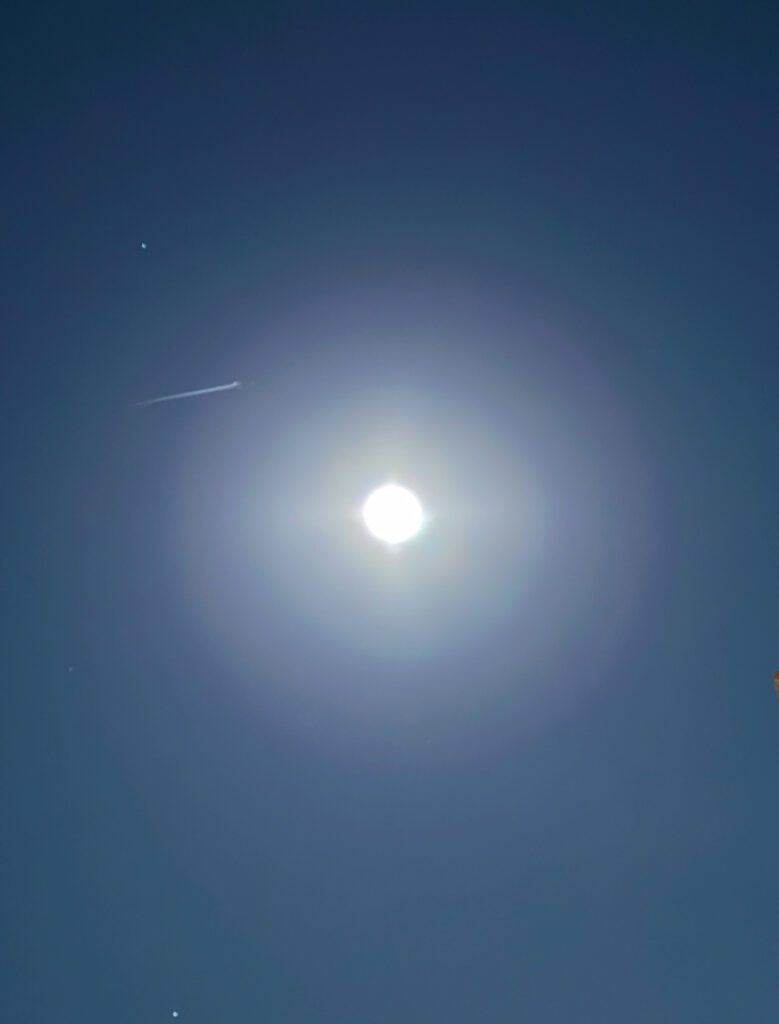 Bright full moon with faint meteor streak