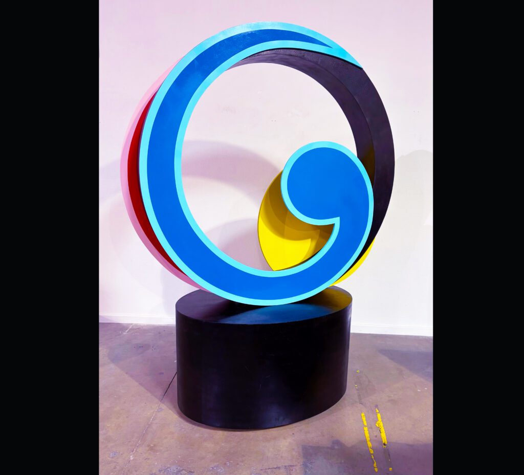 Blue comma-shaped sculpture on black pedestal
