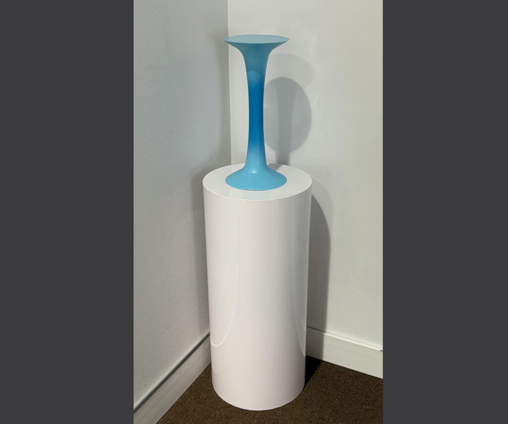 Blue trumpet shaped vase on white pedestal