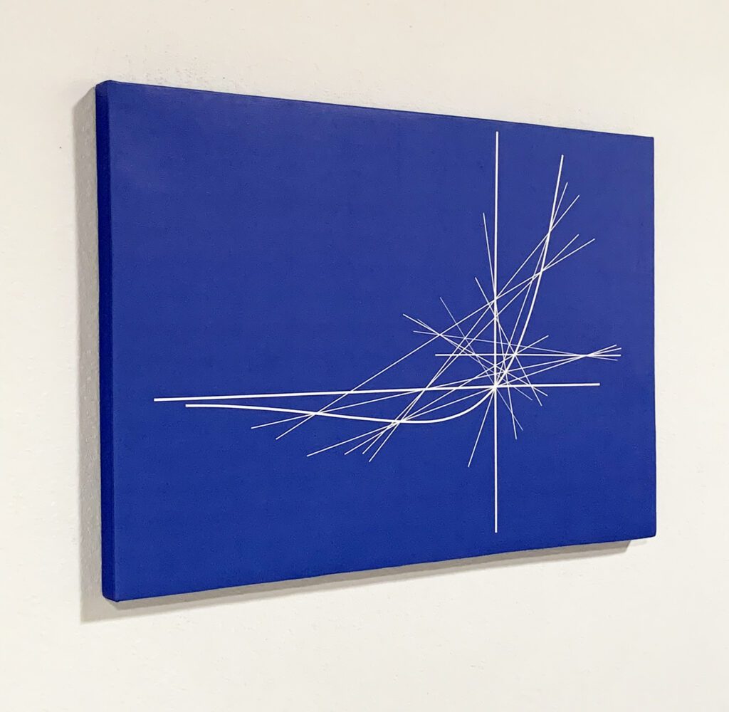 Angled view of blue canvas with white lines